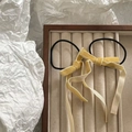 Detailed view of yellow velvet bow hair ties with long ribbons on a velvet jewelry tray - Light Yellow