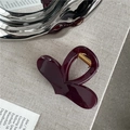 Close-up of deep red heart hair claw clip with glossy finish and gold metal spring - Transparent Wine Red