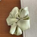 Macro shot of the light green satin hair scrunchie showing glossy fabric texture - Light Green