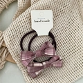 Close-up of two pink and purple plaid bow hair ties on a handmade card packaging - Pink Plaid Bowknot Hair Tie