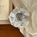 Detailed view of blue and white striped fabric scrunchie with delicate lace trim - Scrunchie / Light Blue (Small)