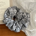 Détail d'un chouchou à carreaux avec broderie florale sur fond de table en bois - Chouchou / Noir (Grand/Brodé)