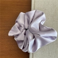 Detailed view of lavender satin fabric texture on a premium soft oversized hair scrunchie - Purple