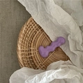 Close-up of a purple wavy hair clip on a woven tray with ins-style aesthetic design - Purple