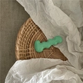 Detail of mint green wavy metal hair clip on a natural woven textured background - Mint Green