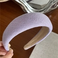 Detail shot of the woven texture and soft inner lining of the thick lavender headband - Purple