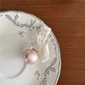 Close-up of lace bow hair clip with light pink faux pearl and delicate floral details - Pink