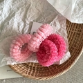 Detailed macro view of three layered pink mesh scrunchies on a textured tray - Mesh Hair Tie / Rose Red + Pink