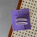 Par de pinzas de pelo ovaladas de color lila mate en una elegante tarjeta de regalo de marca - Morado