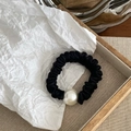 Detailed view of a black satin scrunchie featuring an elegant white faux pearl ornament - Black Thick Style (With Pearl)