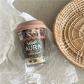 Detail of colorful high elasticity hair ties inside a clear cup with floral packaging - Fruit New Jar / Brown