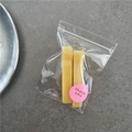 Detail of two yellow rectangular jelly hair clips in packaging with a thank you sticker - Yellow
