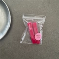 Detail of peach pink rectangular jelly hair clips in packaging with thank you sticker - Rose Red