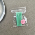 Detail of light green jelly texture hair clips in packaging with a thank you sticker - Green