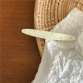 Detailed view of cream-colored hair clip with blue polka dots on a woven background - Cream White (Thin Wave)