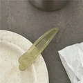 Detail of light green translucent hair clip on decorative plate with a clear resin texture - Green