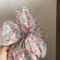 Close-up of lightweight floral organza scrunchie with soft pink and blue flower patterns - White & Red Floral