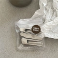Dettaglio di tre fermagli per capelli in metallo argento in confezione artigianale - Stile Misto