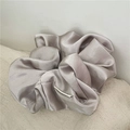 Close-up of a premium champagne oversized satin scrunchie with elegant silk folds - Light Gray