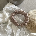 Close-up of champagne satin scrunchie showing smooth silk texture and fabric folds - Small Scrunchie / Grey Coffee