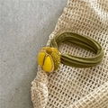 Close-up of 3D durian charm with olive green pleated hair tie on mesh bag - Durian