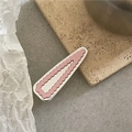 Detail of a pink scalloped edge hair clip with a silver metallic base on a stone tray - Pink Triangle