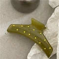 Detailed view of an olive green hair claw clip with yellow rhinestones on a textured floor - Dark Green