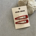 Detail of red teardrop resin hair clips on handmade card with aesthetic coral decor - Transparent Red Coffee Water Drop