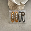 Detailed set of four oval BB hair clips in amber and black with handmade zip packaging - Black and Translucent Brown Oval