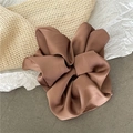 Close-up of premium brown satin scrunchie with soft silk texture and pleated floral design - Large / Orange