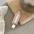 Silver mirror duckbill hair clip with pink wavy edge detail on stone surface - Pink Pear