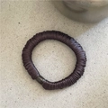 Detail of a dark brown pleated scrunchie with silky luster fabric and cylindrical buckle - Dark Coffee
