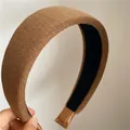 Close-up of brown knitted wide headband showing vertical textured fabric and soft lining - Light Coffee