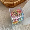 Detail of colorful seamless elastic hair ties set in a cute branded transparent box - Light Green Multicolor