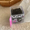 Detail of seamless black hair ties in a cute cartoon box on a cream plush carpet - Black