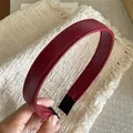 Detail of burgundy PU leather headband with fine stitching and protective black ends - Burgundy