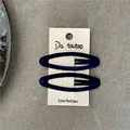 Close-up of a pair of deep blue flocked oval BB hair clips on a beige display card - Navy Blue