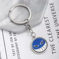 Rotating One Piece metal keychain with blue glitter pendant and smiley face emblem - Blue Glitter Emoji Pattern Style (YSK2310)
