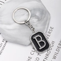 Close-up of hip-hop style rectangular keychain with sparkling rhinestones and letter B - Letter B