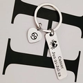 Close-up of Cancer zodiac keychain with engraved heart pendant and date details - Cancer