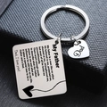 Macro shot of silver stainless steel keychain with Dad heart charm and engraved message - DAD Father's Love Praise Engraved (H)