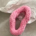 Close-up of a plush pink faux fur hair scrunchie with soft fluffy texture detail - Rose Red