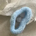 Close-up of a sky blue plush hair claw clip with soft faux sheepskin fleece texture - Blue