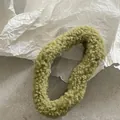 Detailed view of the olive green teddy plush hair scrunchie with soft fuzzy texture - Green