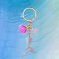 Mermaid keychain with iridescent tail, seashell, and starfish on blue wave background - Purple Fish Tail