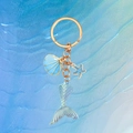 Mermaid tail keychain with blue shell and starfish charms on wave background - Blue Fish Tail