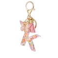 Letter K resin keychain with pink glitter, butterfly charm and soft pink leather tassel - Resin K