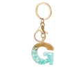 Letter G resin keychain with gold leaf and green stone details on a gold metal ring - Letter G Style