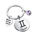 Macro shot of Gemini zodiac keychain with heart pendant and purple crystal stone - Gemini