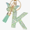 Letter K keychain with green resin, glitter stars, butterfly charm and mint tassel - Green Butterfly K